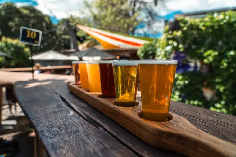 Craft beer flight on a table at an outdoor brewery