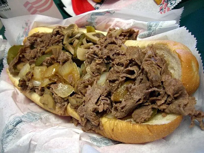 Cheesesteak sandwich with melted cheese on a long roll