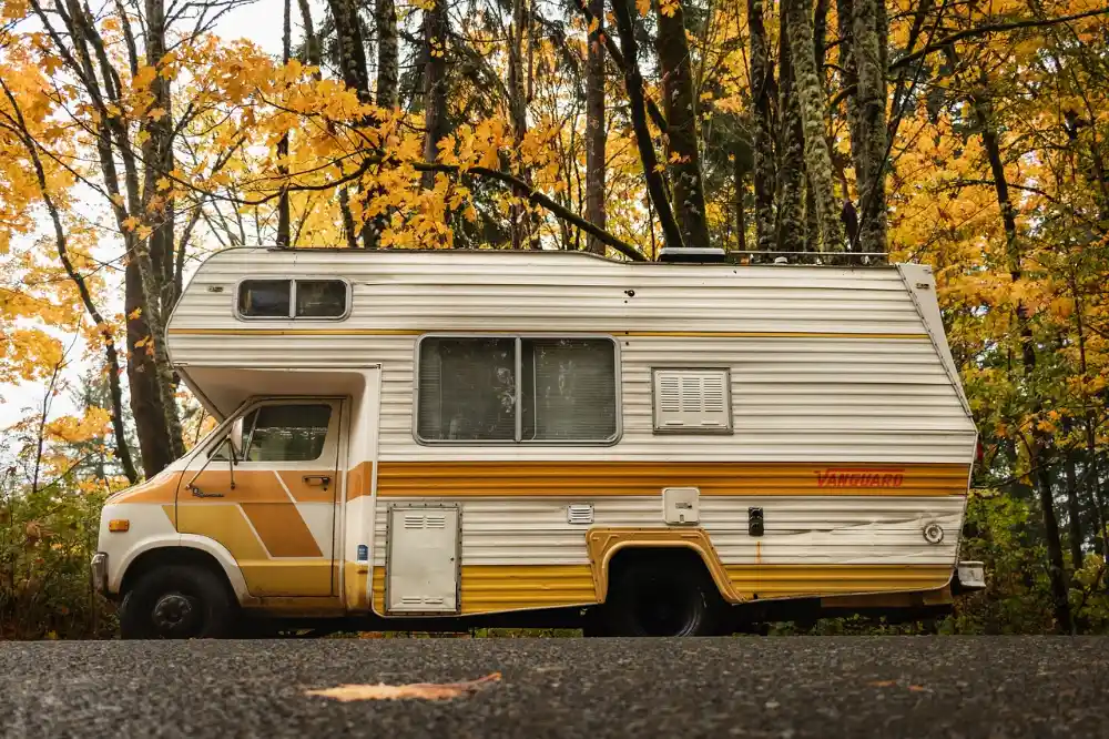 RV parked in an autumn forest, a classic dispersed camping spot